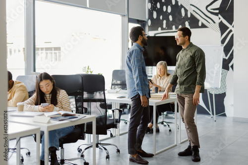 Corporate employees discuss strategy busy workspace