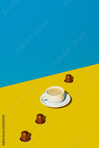 Cup of coffee placed with capsules photo