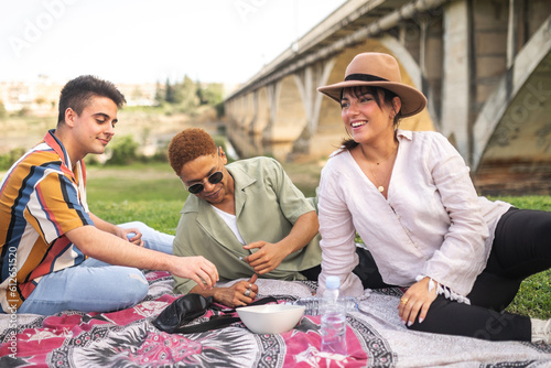 A multicultural picnic in the park with friends photo