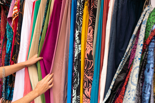 Female Hands Holding Colourful Fabrics