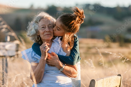 Grandmother carrying her grandson through the field