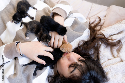 Preteen girl at her bedroom with newborn Foster Kittens photo