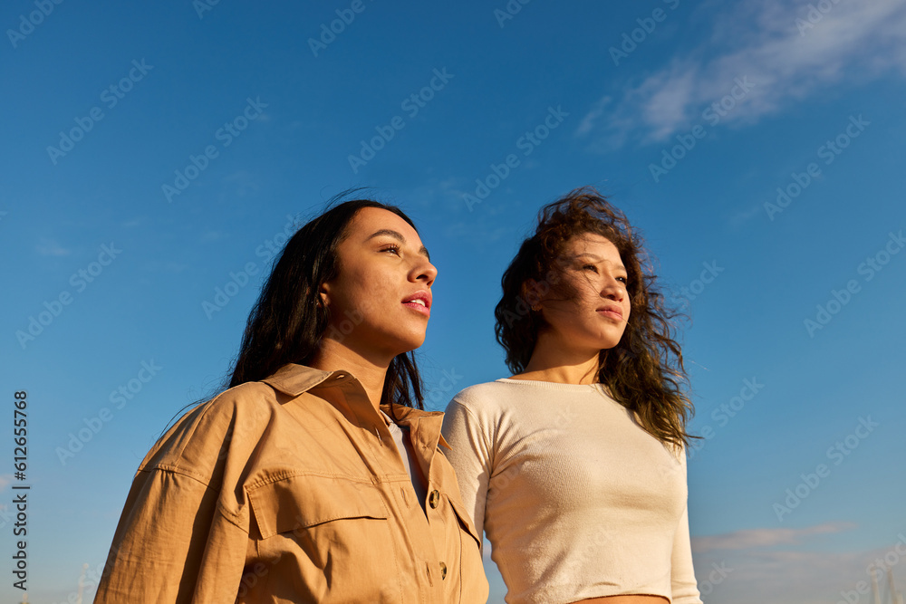 Dreamy young diverse women breathing in sunlight Dreamy young diverse women breathing in sunlight
