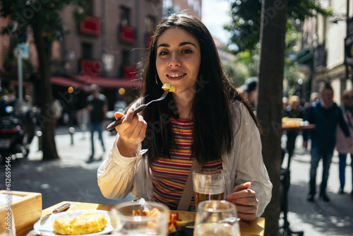 Woman eating spanish tapas and enjoying Madrid city