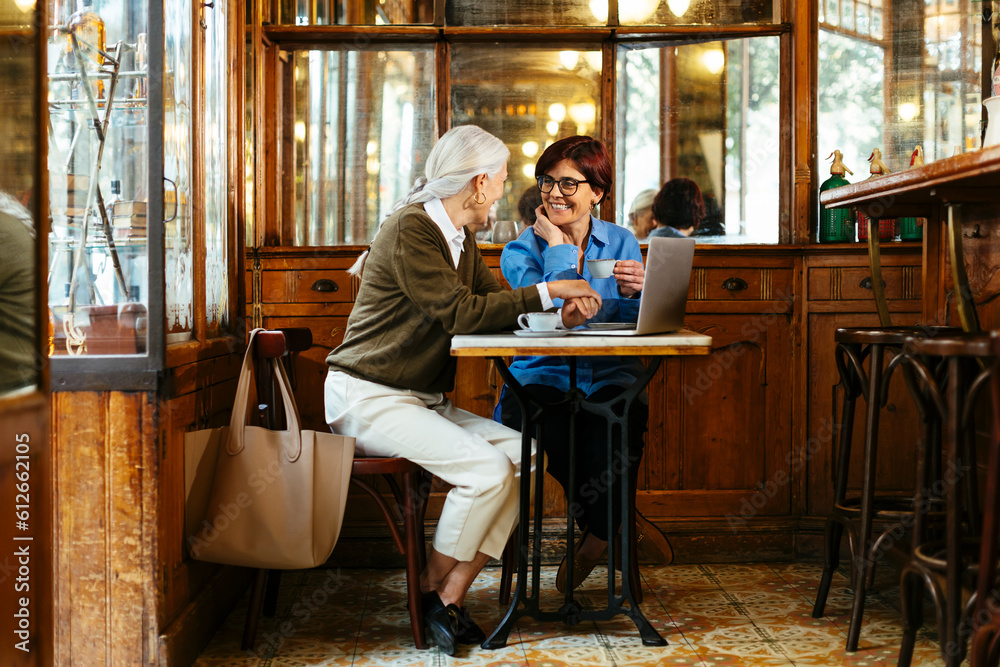 Cheerful senior woman talking in coffee shop Cheerful senior woman talking in coffee shop