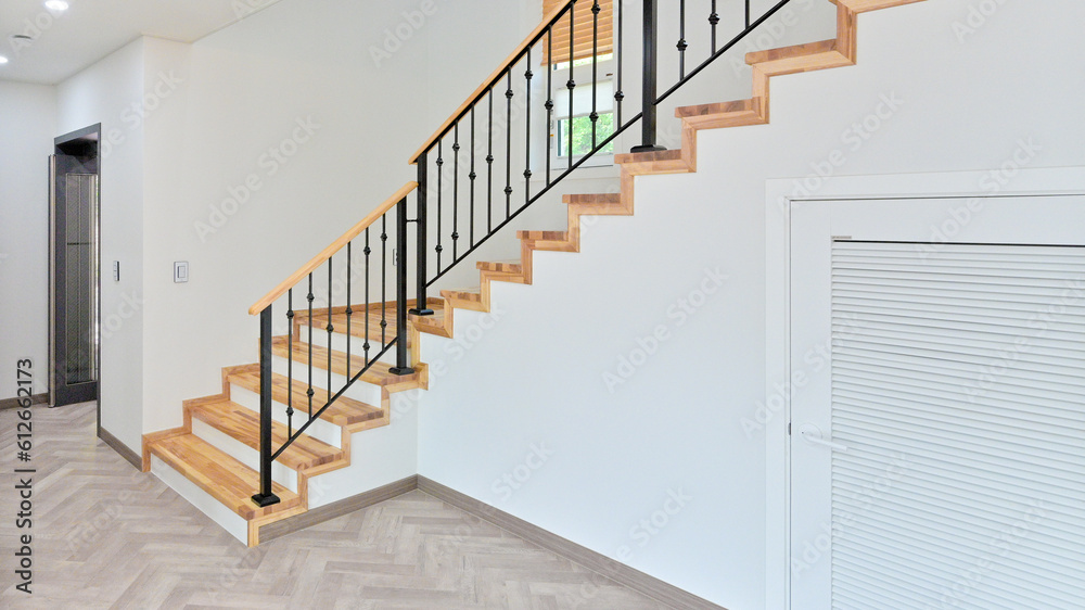 Staircase with black iron frame contrasting with hardwood colored stairwell Staircase with black iron frame contrasting with hardwood colored stairwell