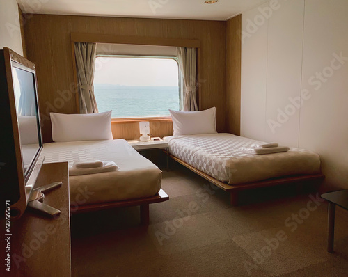 Bedroom with interior of double passenger cabin ferry ship with ocean view.