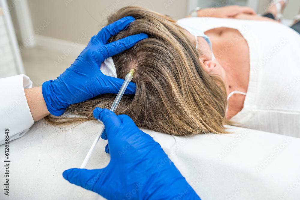 doctor performing hair mesotherapy treatment on woman doctor performing hair mesotherapy treatment on woman