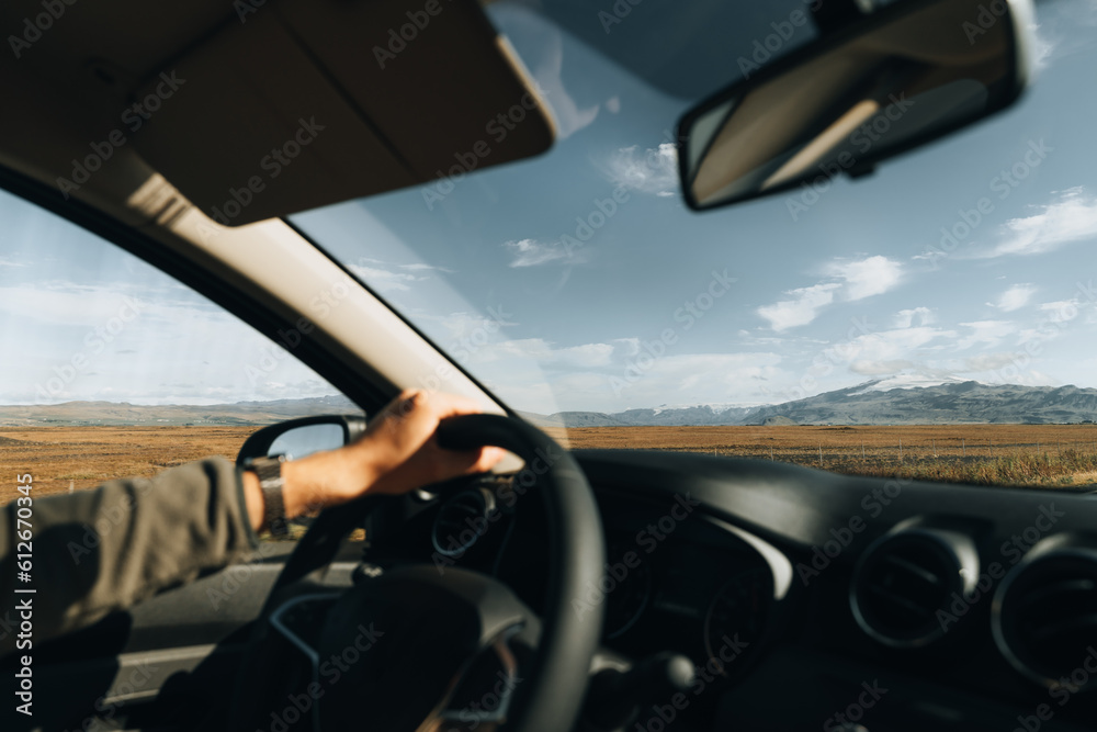 Unrecognizable Man driving car in mountain, hands on wheel. Unrecognizable Man driving car in mountain, hands on wheel.