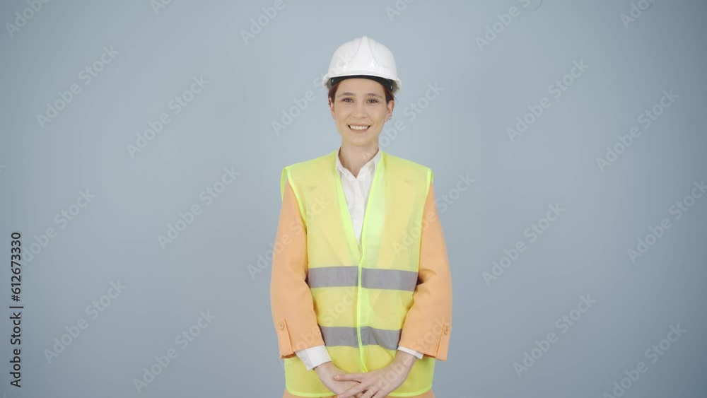 The engineer wearing a hard hat and smiling. The engineer wearing a hard hat and smiling.