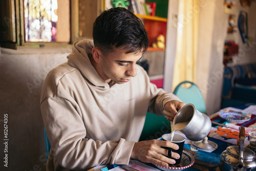 Young tourist man having breakfast in an arabic house photo