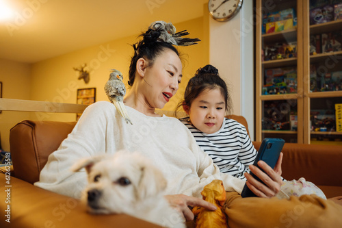 Mother and daughter at home with pets photo