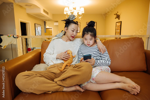 Mother and daughter at home with pets photo