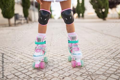 little girl on roller skates in the city photo