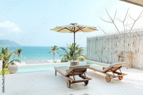 Chaise lounge umbrella and private swimming pool photo