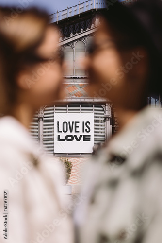 Lesbians hugging against inscription love is love photo