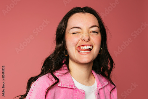 Funny woman portrait on pink wall