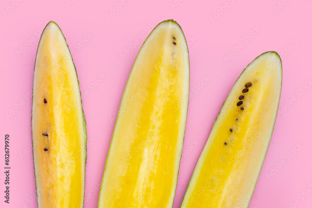 Yellow watermelon on pink background.