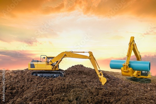 Crawler Excavator is digging in the construction site pipeline .on sunset backgrounds.