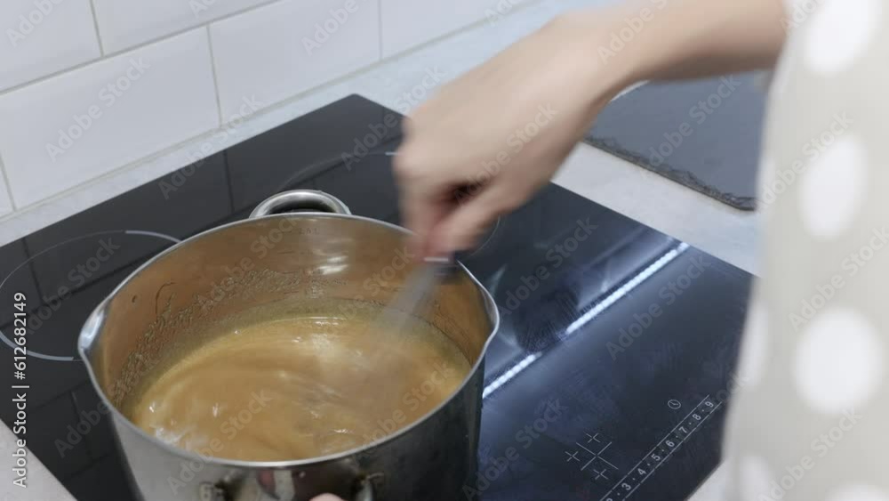 Cooking caramel. pastry chef works at home in the kitchen, mixing ingredients for dough and cream, the process of making dessert Cooking caramel. pastry chef works at home in the kitchen, mixing ingredients for dough and cream, the process of making dessert