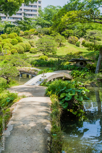 Landscape of footbridge over lake at Shukkeien Gardens in Hiroshima.