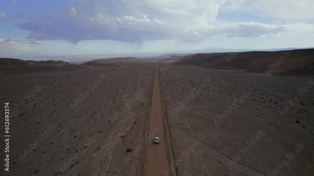 Silver Sedan Driving Dirt Road near San Pedro de Atacama, Driest Desert In The World, Chile. Silver Sedan Driving Dirt Road near San Pedro de Atacama, Driest Desert In The World, Chile.