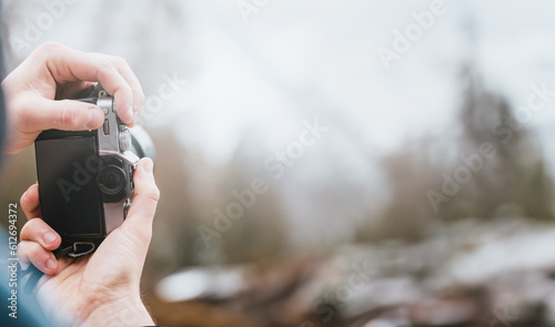 Young Photographer man using Camera to Take Photo. POV Selective focus on LCD Screen mockup