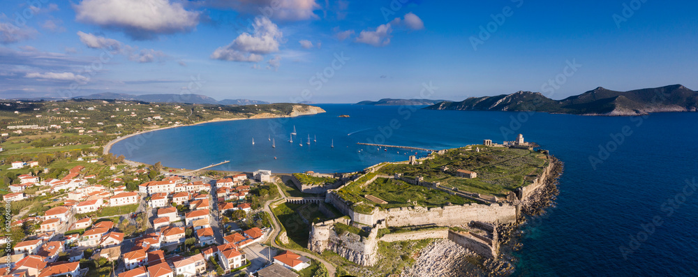 Methoni city in Greece with boats in the bay and the ancient castle