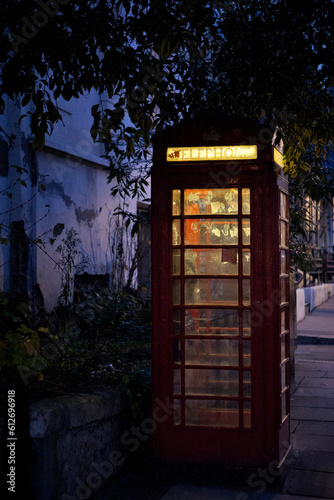 A traditional phone booth at dusk in London, UK.