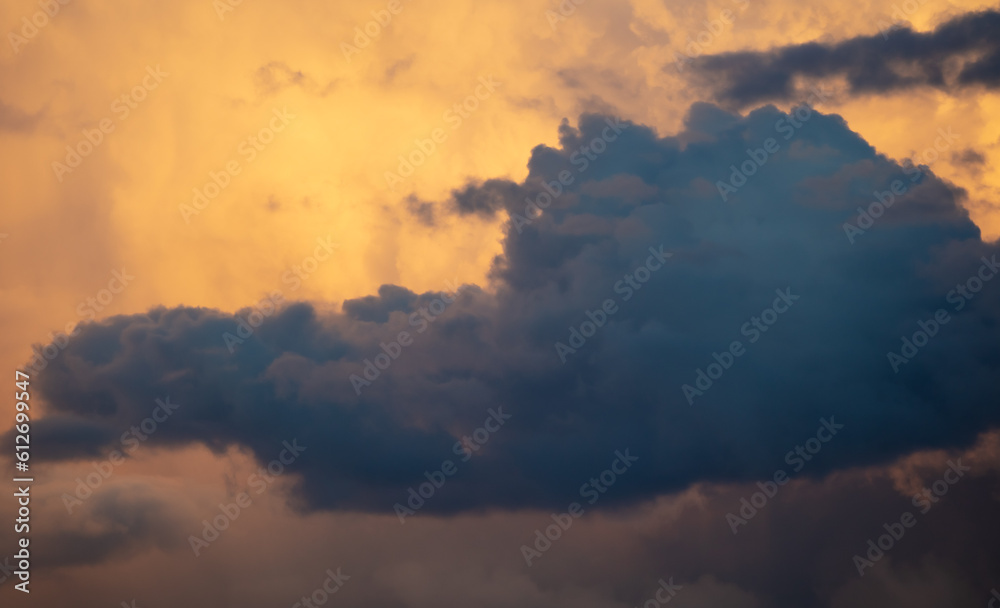Rain clouds at sunset as background