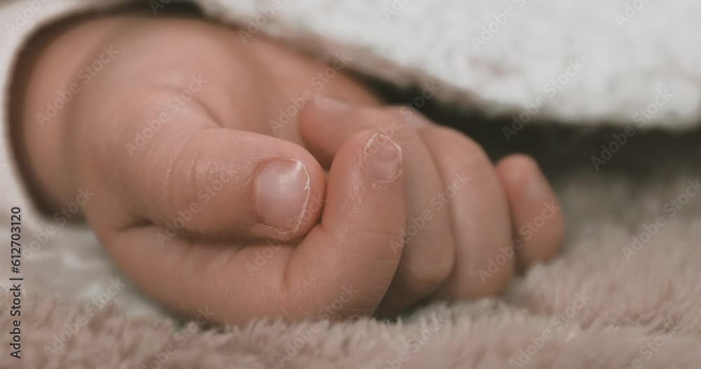 A right hand of sleeping asian baby on the carpet handheld A right hand of sleeping asian baby on the carpet handheld