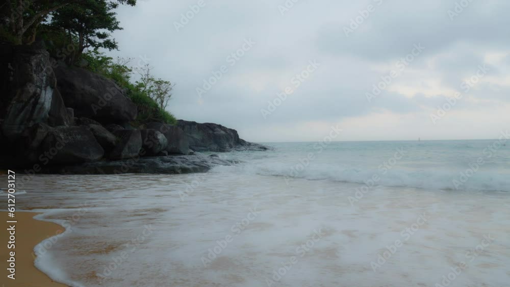 Dreamy shot Of Sea Waves Breaking into Rocks and sandy beach of Con Dao Island. Slow Motion Dreamy shot Of Sea Waves Breaking into Rocks and sandy beach of Con Dao Island. Slow Motion