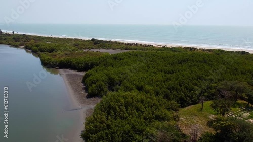 Mouth of River Gambia in Kartong, beautiful cinematic aerial view - Stala Adventures, The Gambia. River meets ocean photo