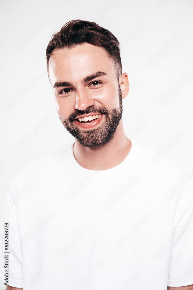 Portrait of handsome smiling stylish hipster lambersexual model. Sexy man dressed in white T-shirt and jeans. Fashion male isolated on white background in studio. Closeup Portrait of handsome smiling stylish hipster lambersexual model. Sexy man dressed in white T-shirt and jeans. Fashion male isolated on white background in studio. Closeup