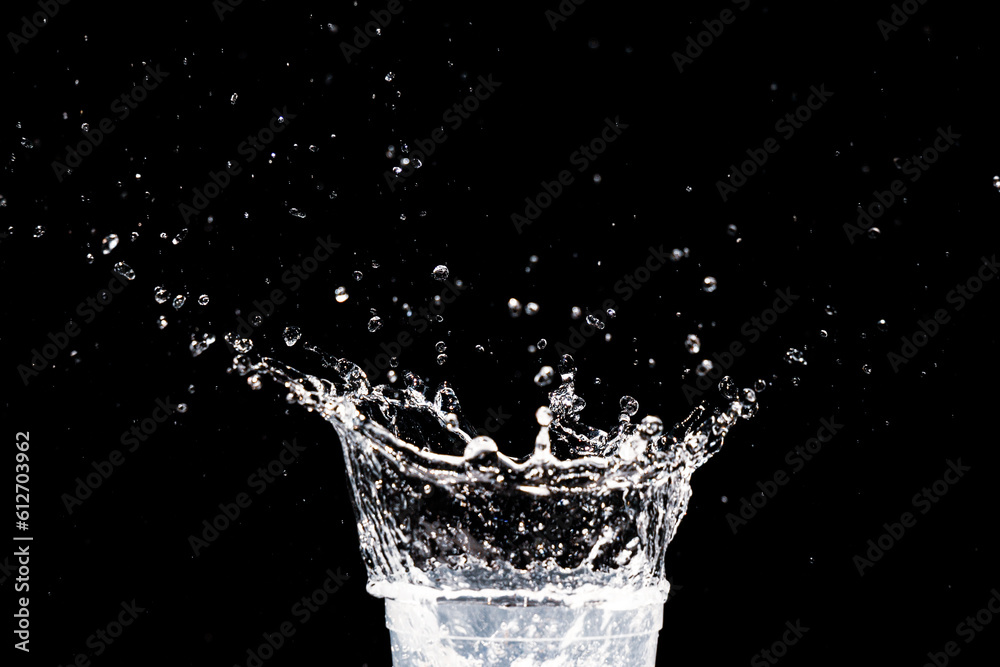 water splash in a glass. water splash isolated on black.