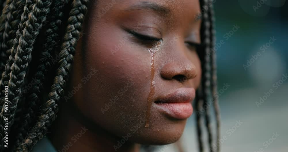 Close-up of a pretty young African woman feeling upset and crying desperately. 