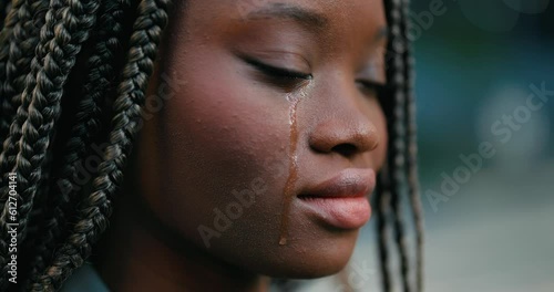 Close-up of a pretty young African woman feeling upset and crying desperately. 
