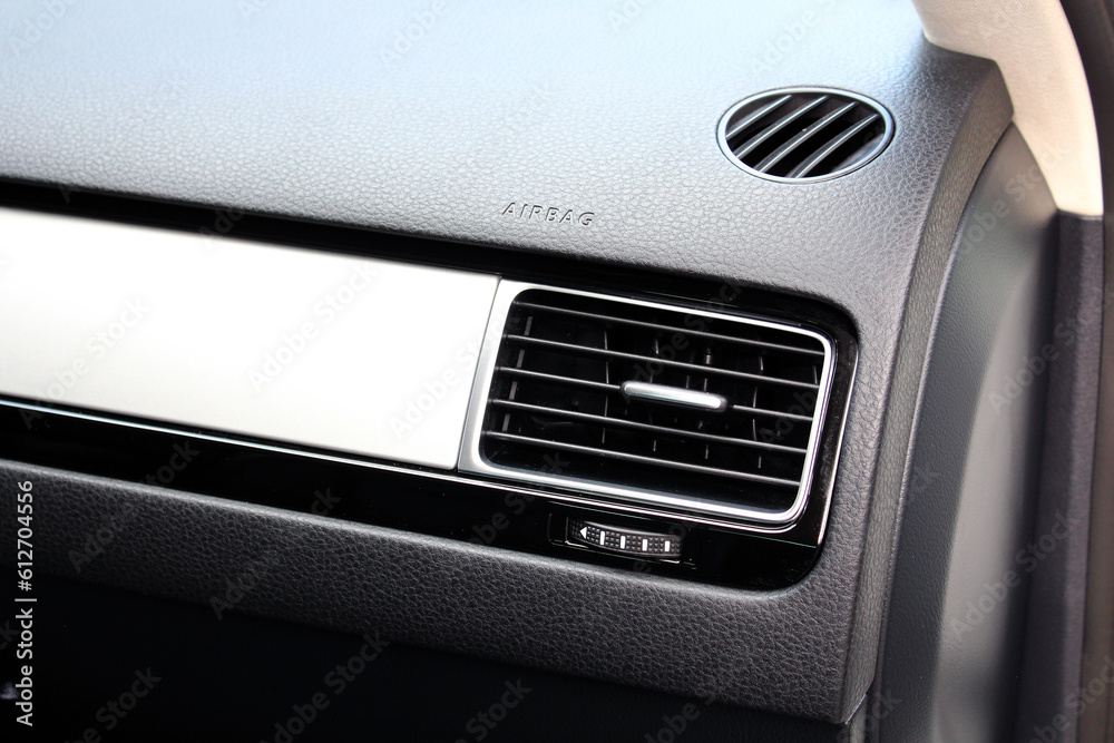 Modern car passenger airbag. Glove compartment in auto interior. Detail of new modern car interior. Black leather interior.
