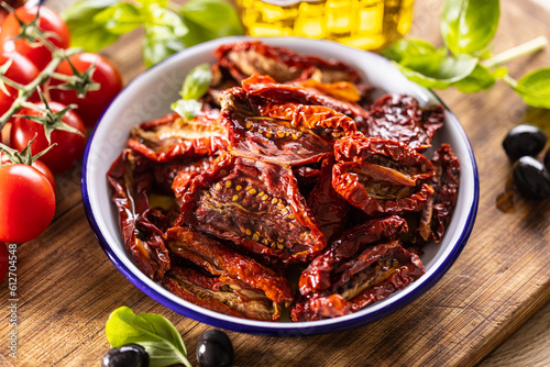 Sun-dried tomatoes marinated in olive oil with herbs and olives