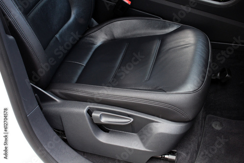 Modern luxury car black leather with alcantara interior. Part of black leather car seat. Interior of prestige car. Leather seats isolated. Adjustable car seat position.