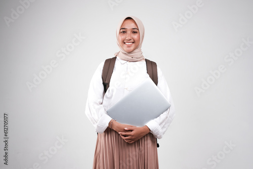 Young muslimah female student is carrying laptop. Prepare back to school isolated white background