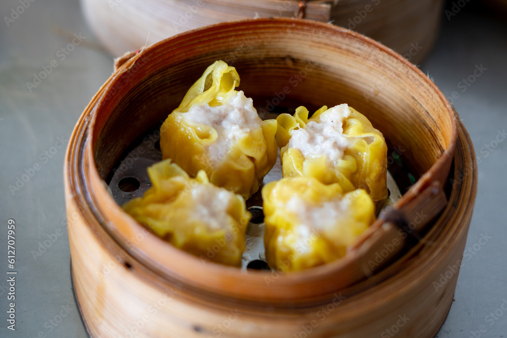 Siu Mai Chinese steamed pork dumplings in bamboo steamers. Stock