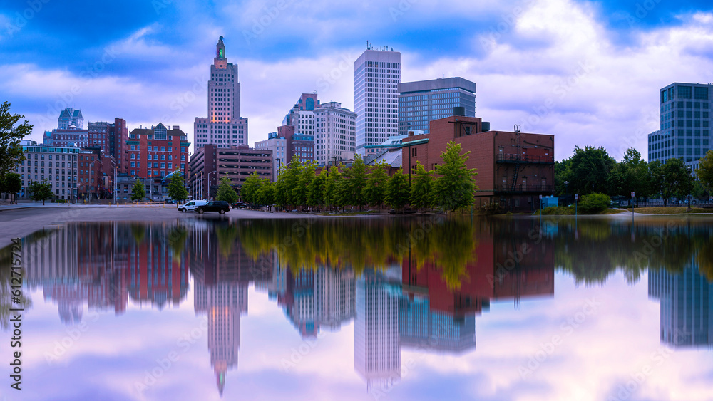 Naklejka premium Metropolitan city skyline of Providence, the Capital of Rhode Island. Vibrant summer cityscape after the storm with water reflections. 