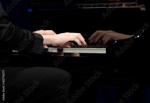 Hand playing on piano photo