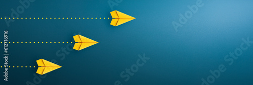 Yellow paper plane on blue background, Success in business growth concept. copy space