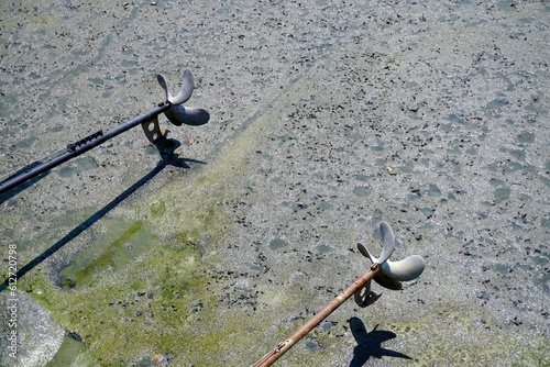 Screw-Propeller of long tail boat and low lide sea surface background photo