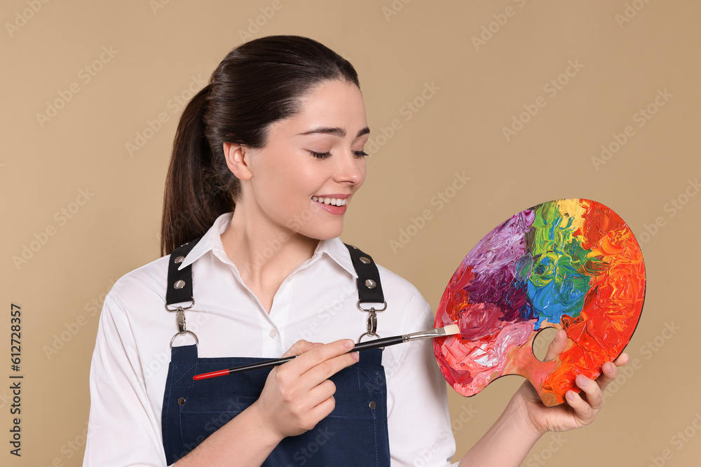 Fototapeta premium Woman with painting tools on beige background. Young artist