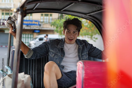 Photography Happy and joyful Young Asian male traveler tourists riding a tuk tuk tour, ricks