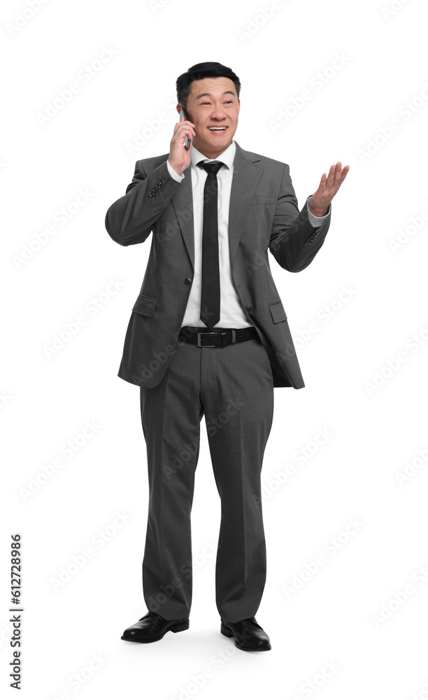 Businessman in suit talking on phone against white background Businessman in suit talking on phone against white background