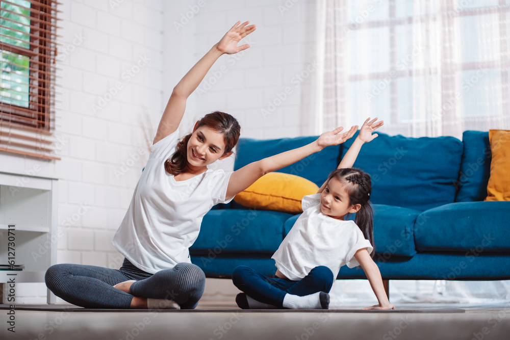 Mother and daughter exercising together happily at home. for flexibility build muscle strength, Sport workout training family together concept. Mother and daughter exercising together happily at home. for flexibility build muscle strength, Sport workout training family together concept.